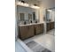 Modern bathroom with double vanity and hexagon tile floor at 13530 W Caribbean Ln, Surprise, AZ 85379