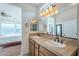 Double vanity bathroom with a view of the bedroom and shower at 1587 E Luminous Ln, Queen Creek, AZ 85140