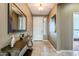 Bright foyer with a console table and large mirror at 1587 E Luminous Ln, Queen Creek, AZ 85140