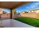 Backyard with covered patio, trampoline, and grass at 174 E Baja Pl, Casa Grande, AZ 85122