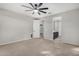 Bedroom with ceiling fan, neutral decor, and door to bathroom at 18625 W Elm St, Goodyear, AZ 85395