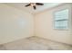 Bright bedroom with carpeted floor, window blinds, and ceiling fan at 2039 N 213Th Ln, Buckeye, AZ 85396