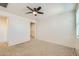 Spacious bedroom with carpeted floor and ceiling fan at 2039 N 213Th Ln, Buckeye, AZ 85396