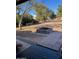 Backyard patio with fire pit and mature trees at 22744 E Carla Vista Dr, Mesa, AZ 85212