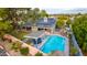 An aerial view of a house with a solar panel system and a sparkling blue pool at 2328 N Roca St, Mesa, AZ 85213