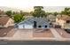 Exterior view of a house with a three-car garage and well-maintained yard at 2328 N Roca St, Mesa, AZ 85213