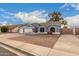 Gray house with three-car garage, landscaped yard, and American flag at 2328 N Roca St, Mesa, AZ 85213