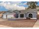Gray house with three-car garage, landscaped yard, and American flag at 2328 N Roca St, Mesa, AZ 85213