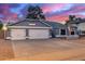 Gray house with three-car garage and landscaped yard at 2328 N Roca St, Mesa, AZ 85213