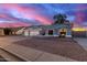 Gray house with three-car garage, landscaped yard, and American flag at 2328 N Roca St, Mesa, AZ 85213