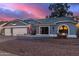 Gray house with three-car garage, landscaped yard, and American flag at 2328 N Roca St, Mesa, AZ 85213
