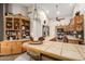 Open kitchen with breakfast bar, wood cabinets, and tiled countertops at 2328 N Roca St, Mesa, AZ 85213