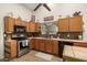Bright kitchen with stainless steel appliances and wood cabinets at 2328 N Roca St, Mesa, AZ 85213