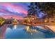 Inviting kidney-shaped pool with a Route 66 themed patio cover at 2328 N Roca St, Mesa, AZ 85213