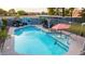 Inviting kidney-shaped pool with Route 66 mural and patio furniture at 2328 N Roca St, Mesa, AZ 85213
