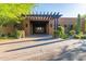 Elegant community entrance with a covered pergola and desert landscaping at 25515 N Forest Rd # 1, Rio Verde, AZ 85263