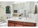 Bathroom with double sinks, large mirror, and decorative cabinet at 29214 N 19Th Ln, Phoenix, AZ 85085