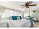 Spacious bedroom with a large bed, ceiling fan, and mirrored closet doors at 3104 E Broadway Rd # 22, Mesa, AZ 85204