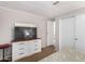 Bedroom with large TV, dresser, and view into another room at 3104 E Broadway Rd # 22, Mesa, AZ 85204