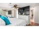 Bright bedroom with large TV, dresser, and ensuite bathroom access at 3104 E Broadway Rd # 22, Mesa, AZ 85204