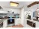 Updated kitchen boasts white cabinets, stainless steel appliances, and stylish backsplash at 3104 E Broadway Rd # 22, Mesa, AZ 85204