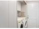 Laundry room with washer, dryer, and ironing board at 3104 E Broadway Rd # 22, Mesa, AZ 85204