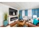Living room with a modern electric fireplace and a large flat-screen TV at 3104 E Broadway Rd # 22, Mesa, AZ 85204