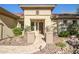 Front entry with a curved walkway, landscaping, and a dark brown door at 41120 N Congressional Dr, Anthem, AZ 85086