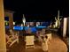 Night view of a relaxing pool area with fire pit and seating at 41120 N Congressional Dr, Anthem, AZ 85086