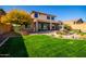 Large backyard with two-story home, fountain, and lush grass at 43301 N National Trl, Anthem, AZ 85086