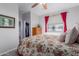 Bedroom with floral bedding, built-in shelving, and large window at 43301 N National Trl, Anthem, AZ 85086