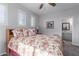 Bedroom with floral bedding and adjacent bathroom at 43301 N National Trl, Anthem, AZ 85086