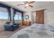 Main bedroom with barn door, sitting area, and mountain views at 43301 N National Trl, Anthem, AZ 85086