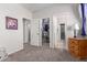 Hallway with carpet flooring and access to bedrooms and closets at 43301 N National Trl, Anthem, AZ 85086