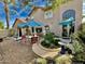 Relaxing backyard patio with seating area, umbrella, and built-in grill at 4444 E Wildwood Dr, Phoenix, AZ 85048
