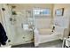 Bathroom with shower and tub combination, and large window at 4444 E Wildwood Dr, Phoenix, AZ 85048