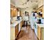 Kitchen with wood cabinets, white appliances, and laminate flooring at 4444 E Wildwood Dr, Phoenix, AZ 85048