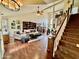 Spacious living room with hardwood floors, a stone fireplace, and high ceilings at 4444 E Wildwood Dr, Phoenix, AZ 85048