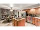 Kitchen with island, stainless steel appliances, and wood cabinets at 47012 N New River Rd, New River, AZ 85087