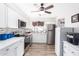 Updated kitchen with white shaker cabinets, mosaic backsplash, and stainless steel appliances at 5627 E Covina Rd, Mesa, AZ 85205