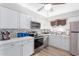 Updated kitchen with white shaker cabinets, mosaic backsplash, and stainless steel appliances at 5627 E Covina Rd, Mesa, AZ 85205