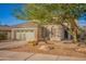 Two-story house with a green garage door and mature tree at 6234 W Maya Dr, Phoenix, AZ 85083