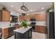 Modern kitchen with light wood cabinets, white hexagon backsplash, and a large kitchen island at 6234 W Maya Dr, Phoenix, AZ 85083