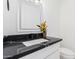 Modern bathroom with black countertop and sink at 6425 W Campbell Ave, Phoenix, AZ 85033