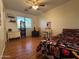 Bright bedroom with wood floors, comfy chair, and ample closet space at 7452 E June St, Mesa, AZ 85207