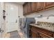 Laundry room with granite countertop, wood cabinets, and washer/dryer at 945 W Elm St, Litchfield Park, AZ 85340