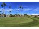 Putting green overlooking a scenic lake with palm trees at 1033 S Florence Dr, Mesa, AZ 85208