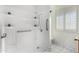 Clean bathroom with a walk-in shower and grab bars at 10652 W Saratoga Cir, Sun City, AZ 85351