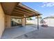 Covered patio with ceiling fan and fire pit at 1602 W Behrend Dr, Phoenix, AZ 85027