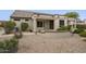 Home's exterior showcases a covered patio and desert landscaping at 17327 N Potomac Ln, Surprise, AZ 85374